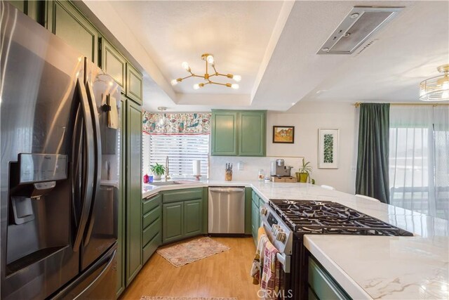 kitchen featuring green cabinets, stainless steel appliances, and light countertops