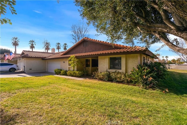 view of front of property with a garage, driveway, a tiled roof, a front yard, and stucco siding