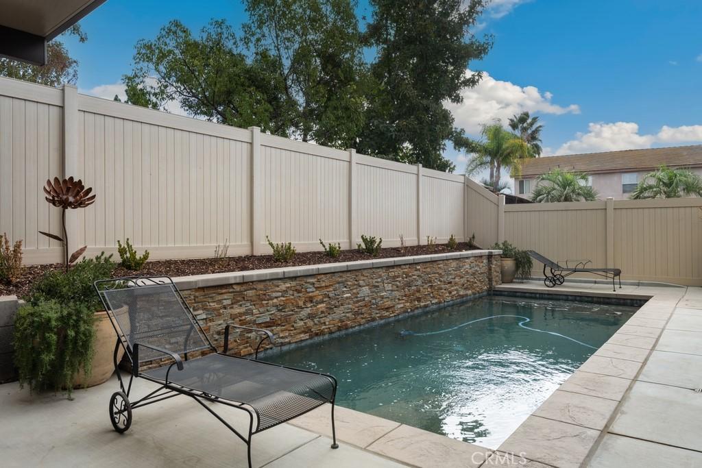 view of pool with a patio area, a fenced backyard, and a fenced in pool