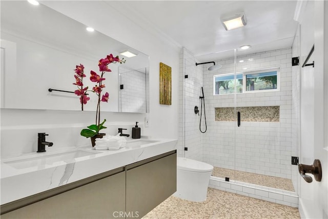 bathroom featuring vanity, a shower with shower door, and toilet