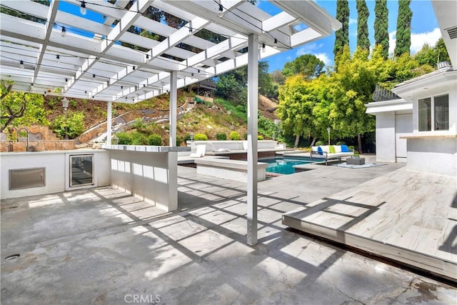 view of patio / terrace with area for grilling, an outdoor living space, beverage cooler, and a pergola