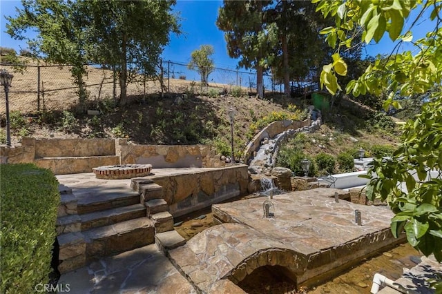 view of patio / terrace with a fire pit