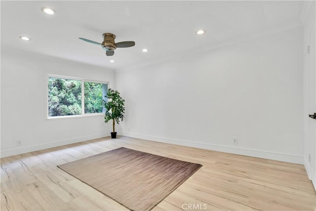 empty room featuring ceiling fan, crown molding, and light wood-type flooring