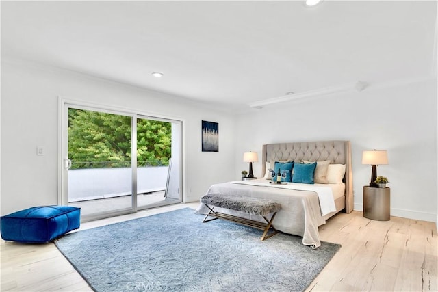 bedroom featuring access to exterior and light wood-type flooring