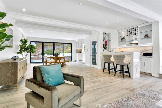 living room featuring crown molding and light hardwood / wood-style floors