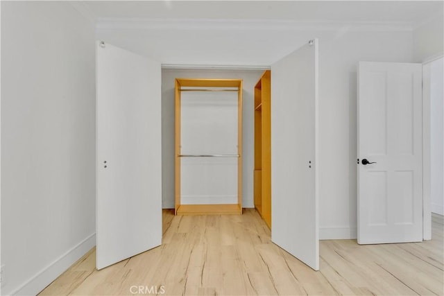 corridor with ornamental molding and wood-type flooring