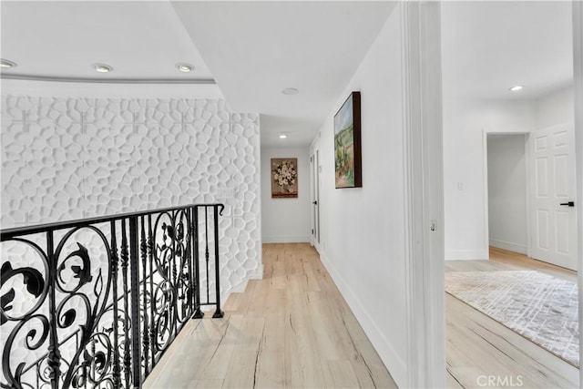 corridor with light hardwood / wood-style flooring