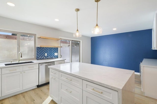 kitchen with white cabinetry, dishwasher, sink, and pendant lighting