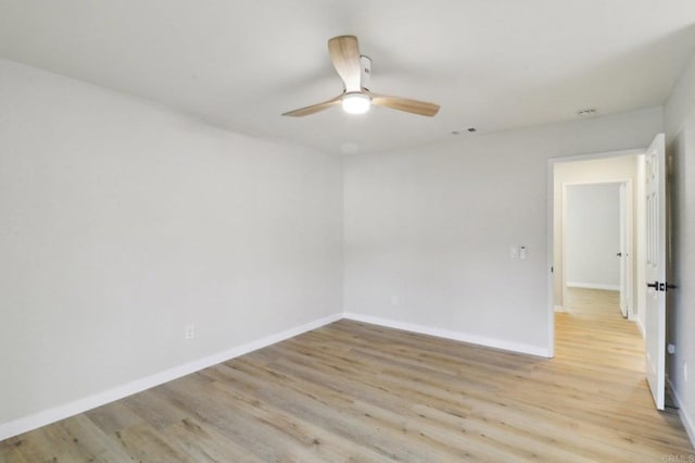 empty room featuring ceiling fan and light wood-type flooring