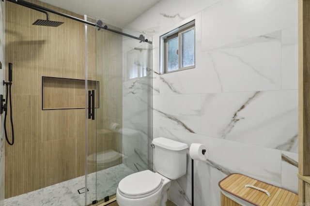 bathroom with tile walls, an enclosed shower, and toilet