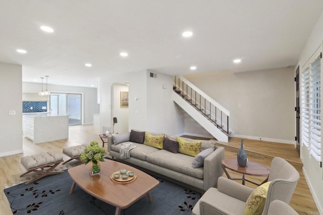 living room featuring recessed lighting, stairway, a wealth of natural light, and wood finished floors