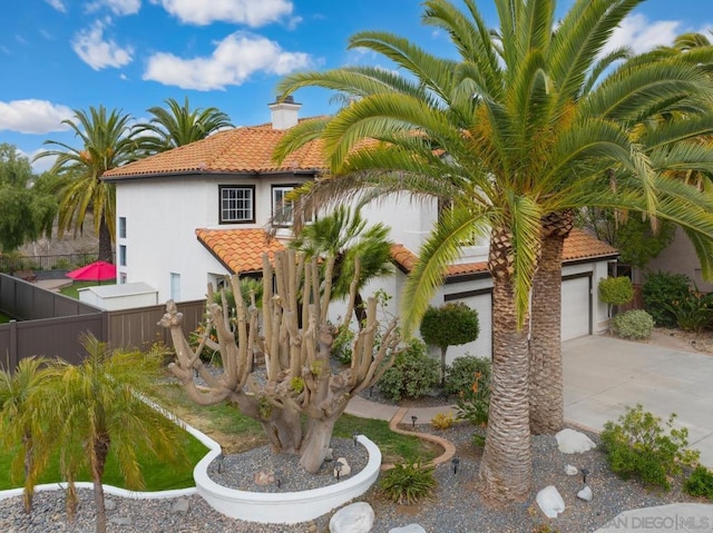 mediterranean / spanish-style house with a garage