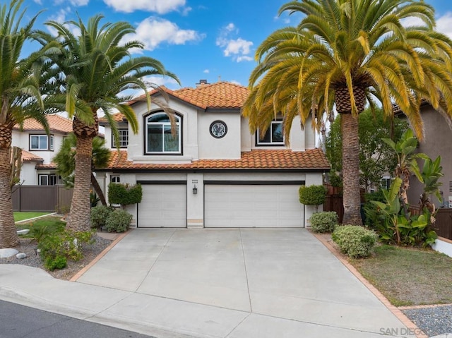 mediterranean / spanish-style house with a garage