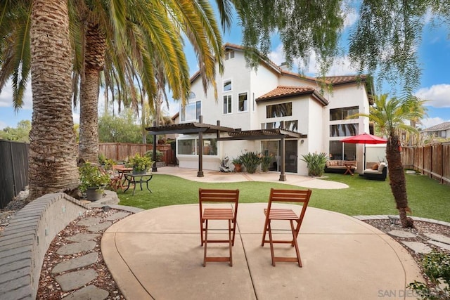 rear view of house featuring a patio, a yard, and a pergola