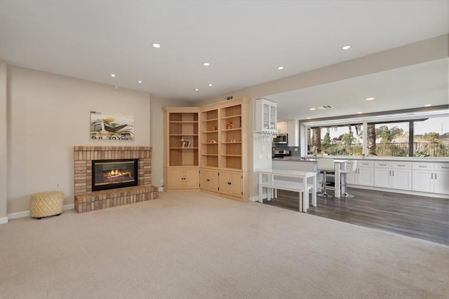 unfurnished living room with a fireplace and dark carpet