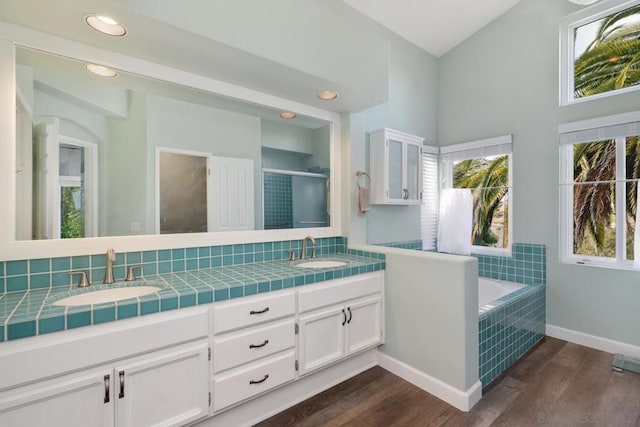 bathroom with vanity, separate shower and tub, and hardwood / wood-style floors