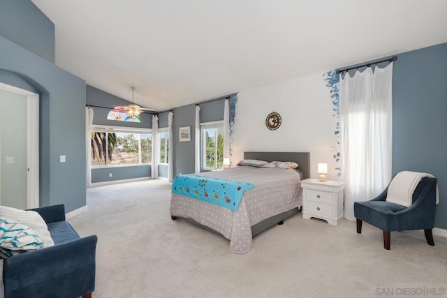 carpeted bedroom featuring lofted ceiling