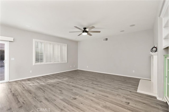 unfurnished room featuring hardwood / wood-style floors and ceiling fan