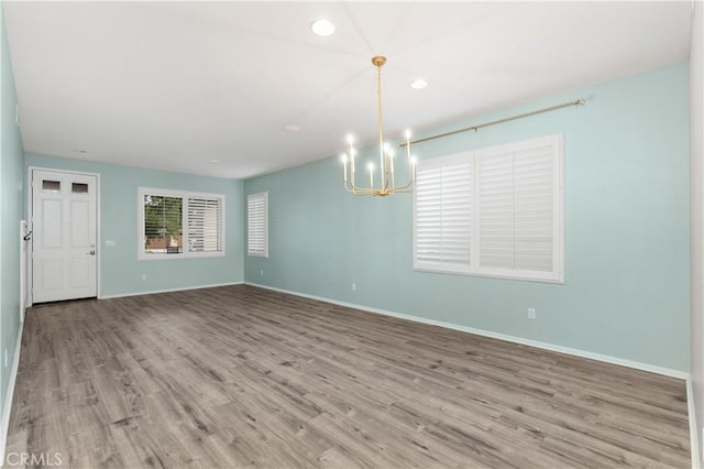 interior space with a chandelier and light hardwood / wood-style floors