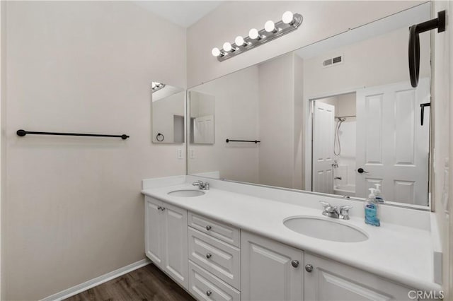 bathroom featuring vanity, wood-type flooring, and bathtub / shower combination