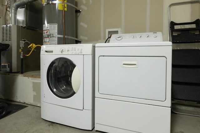 washroom with washing machine and dryer, heating unit, and secured water heater