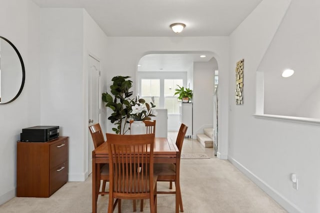 dining space with light colored carpet