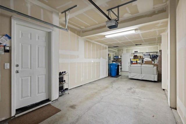 garage featuring a garage door opener and washer and dryer