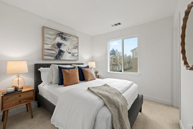 bedroom featuring light carpet