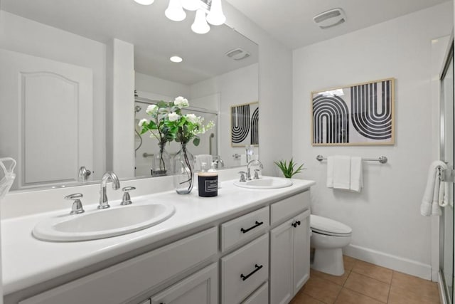 bathroom with vanity, toilet, an enclosed shower, and tile patterned flooring