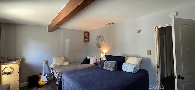 bedroom with visible vents and beamed ceiling