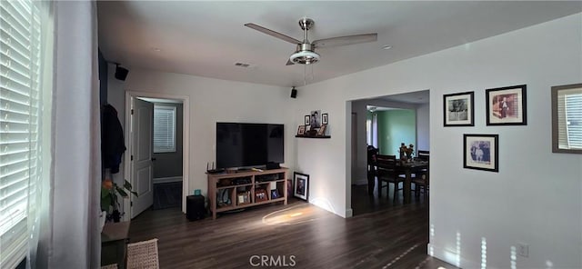 living area with dark wood-style floors and ceiling fan