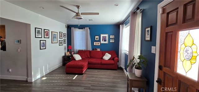 living area featuring baseboards, ceiling fan, visible vents, and wood finished floors