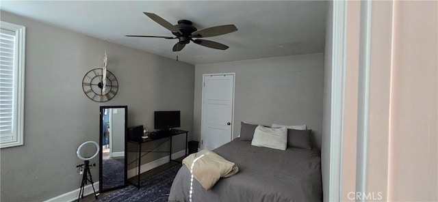 bedroom featuring a ceiling fan and baseboards