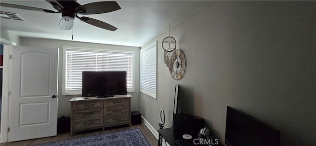 bedroom with visible vents, dark wood finished floors, and a ceiling fan