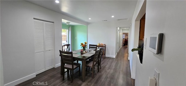 dining area featuring baseboards, dark wood finished floors, and recessed lighting