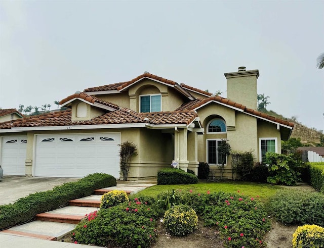 mediterranean / spanish-style house featuring a garage