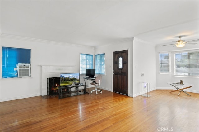 entryway with crown molding, a brick fireplace, hardwood / wood-style flooring, and a wealth of natural light