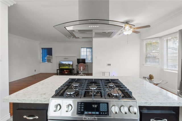 kitchen featuring ceiling fan, stainless steel range, ornamental molding, and dark hardwood / wood-style flooring