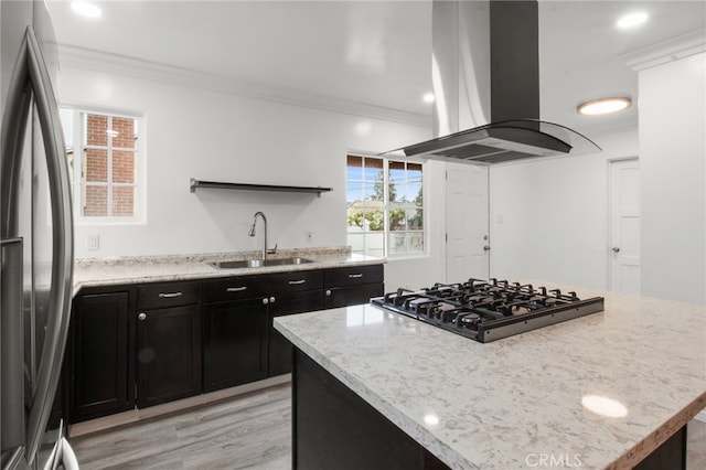 kitchen with a kitchen island, island range hood, sink, fridge, and black gas stovetop