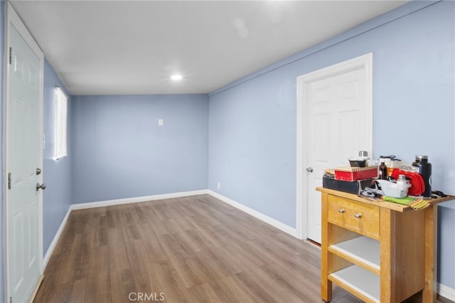 unfurnished room with wood-type flooring