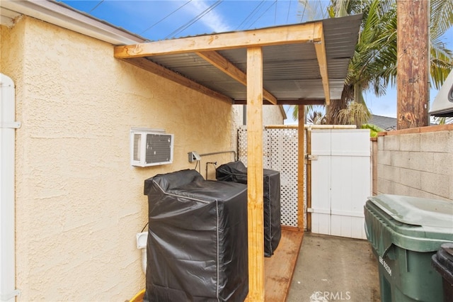 view of patio / terrace with area for grilling and a wall mounted air conditioner