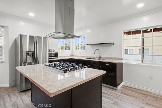 kitchen with sink, light stone counters, appliances with stainless steel finishes, a kitchen island, and island exhaust hood