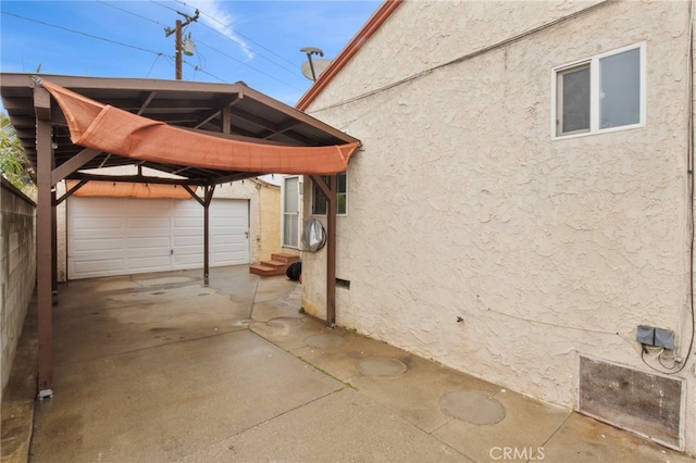 view of property exterior featuring a gazebo, a garage, and an outdoor structure