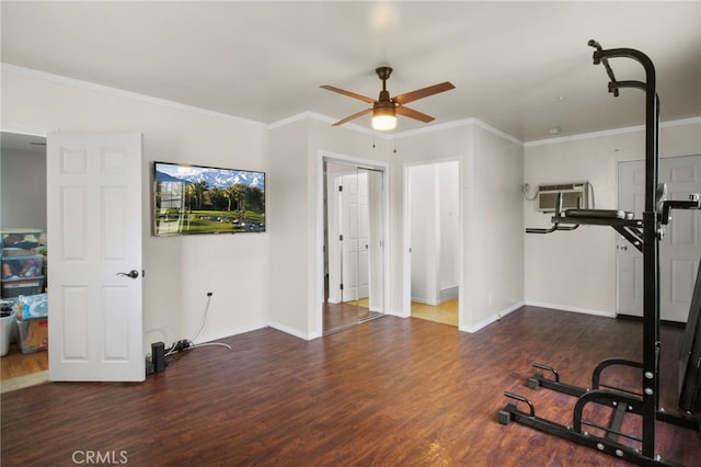 exercise area with dark wood-type flooring, ceiling fan, crown molding, and a wall mounted AC