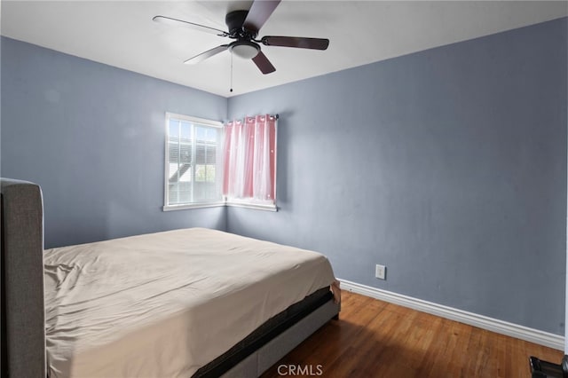 bedroom featuring ceiling fan and dark hardwood / wood-style flooring