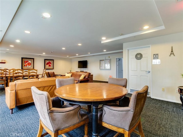 dining area featuring dark colored carpet