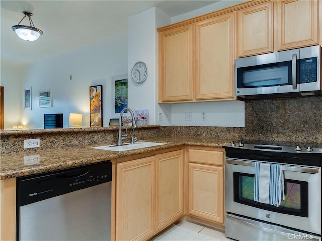 kitchen featuring light brown cabinetry, tasteful backsplash, sink, dark stone countertops, and stainless steel appliances