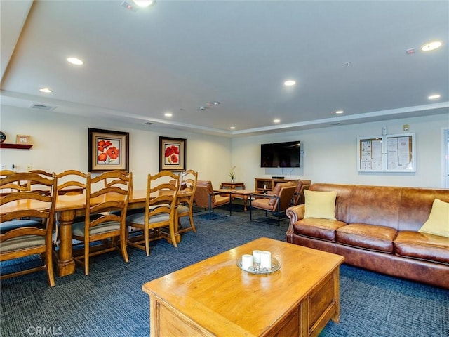 living room with dark colored carpet