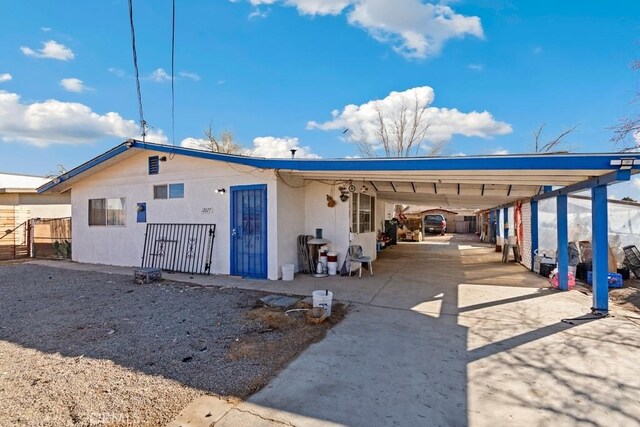 rear view of property featuring a carport