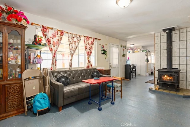 living room with concrete floors and a wood stove